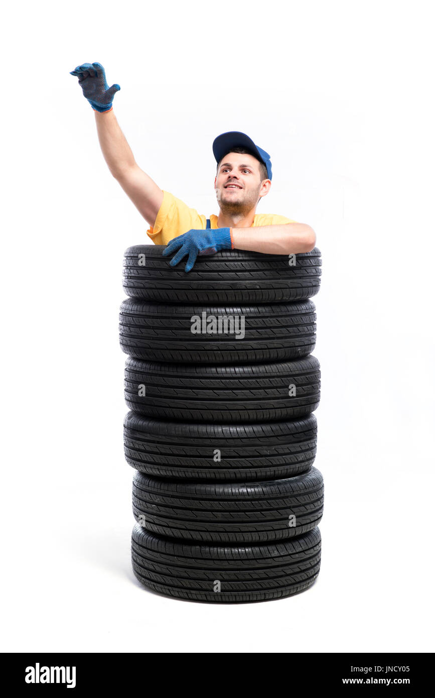 Car tire service, repairman hand up, white background, garage worker with tyres, wheel mounting Stock Photo