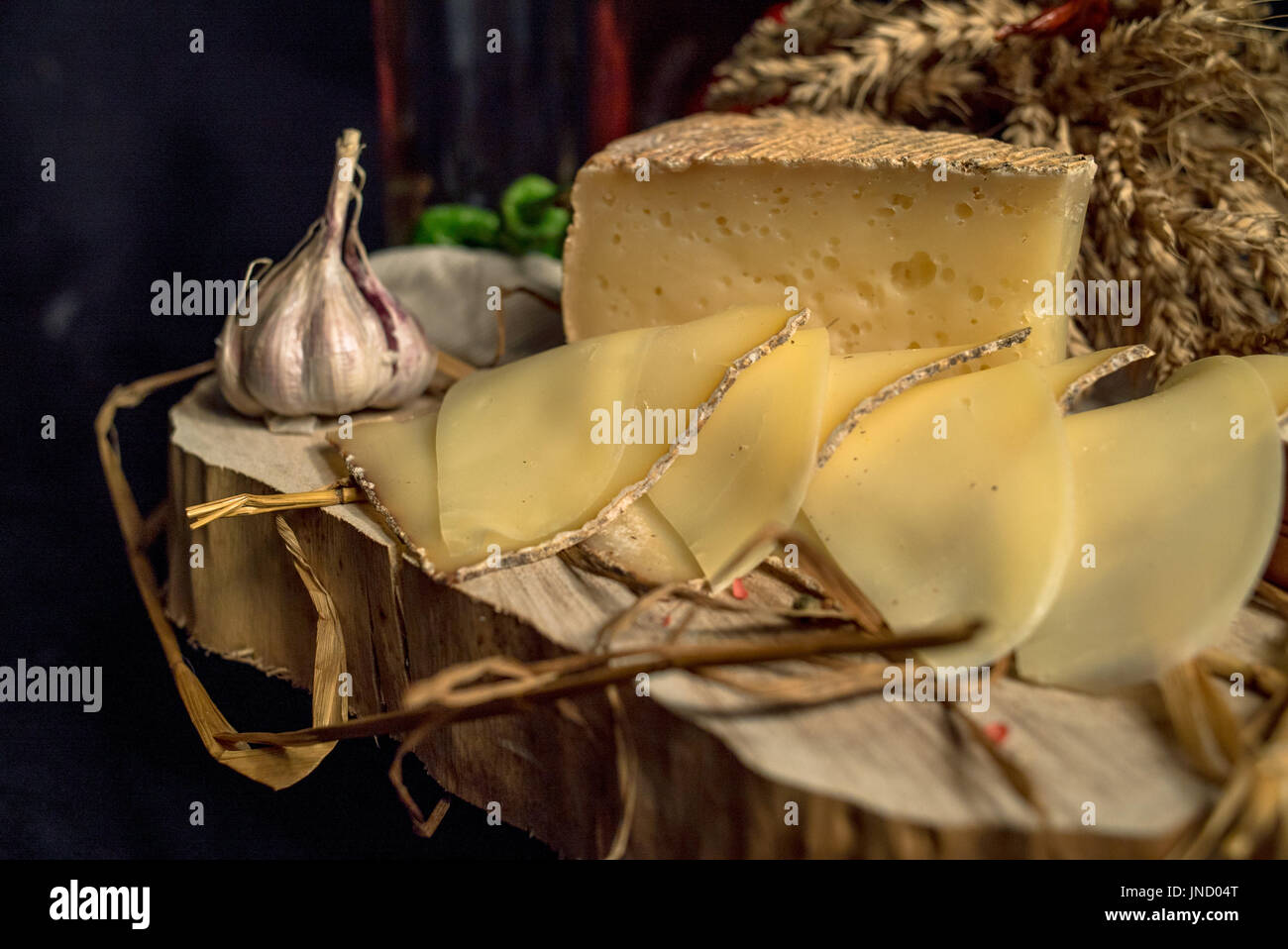 Handmade Cheese Sliced handmade cheese on a wood board and black background Stock Photo ...