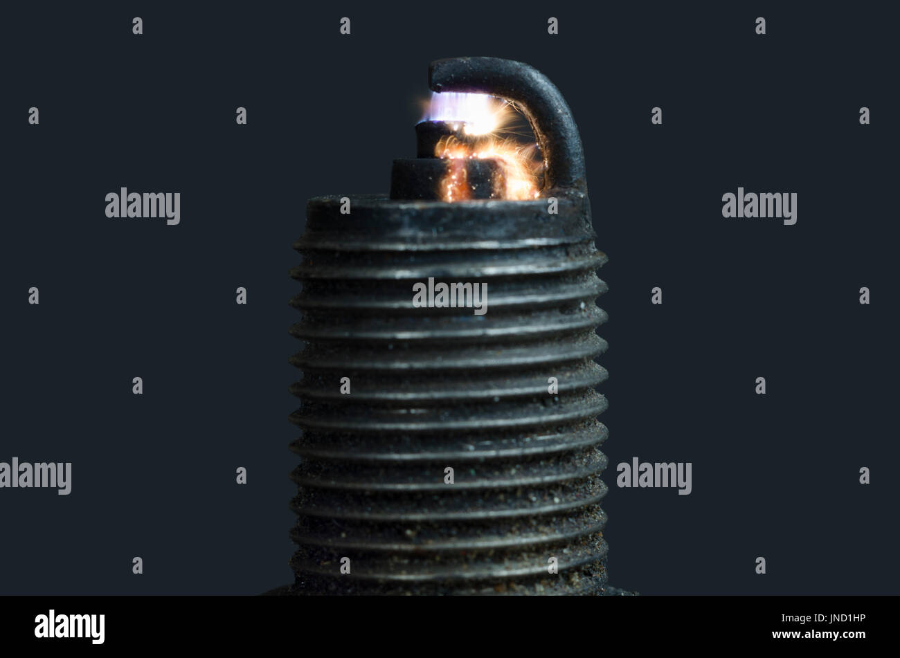 Old broken dirty spark plug with amazing sparkle; isolated Stock Photo