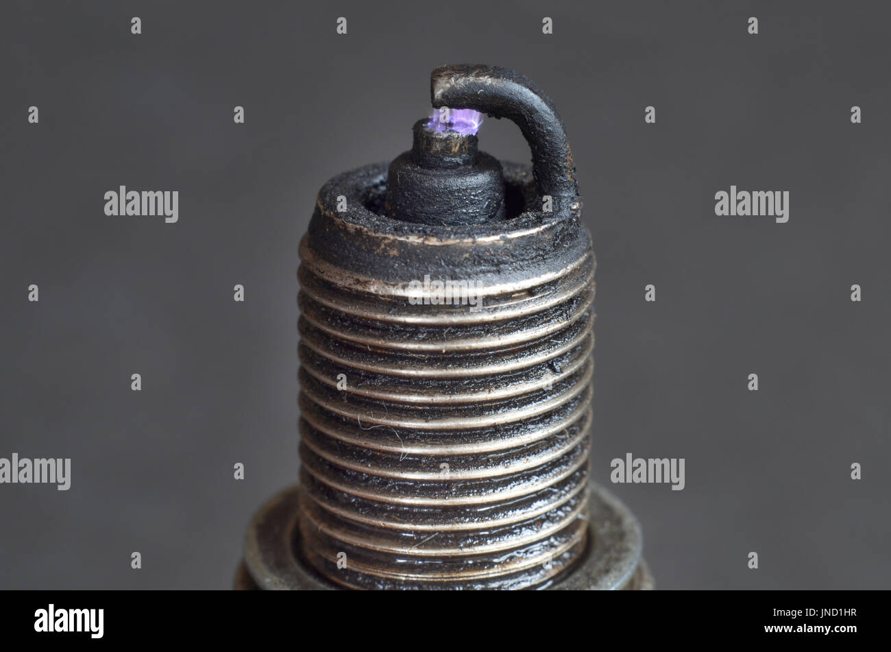 Broken dirty spark plug with blue sparkle Stock Photo Alamy