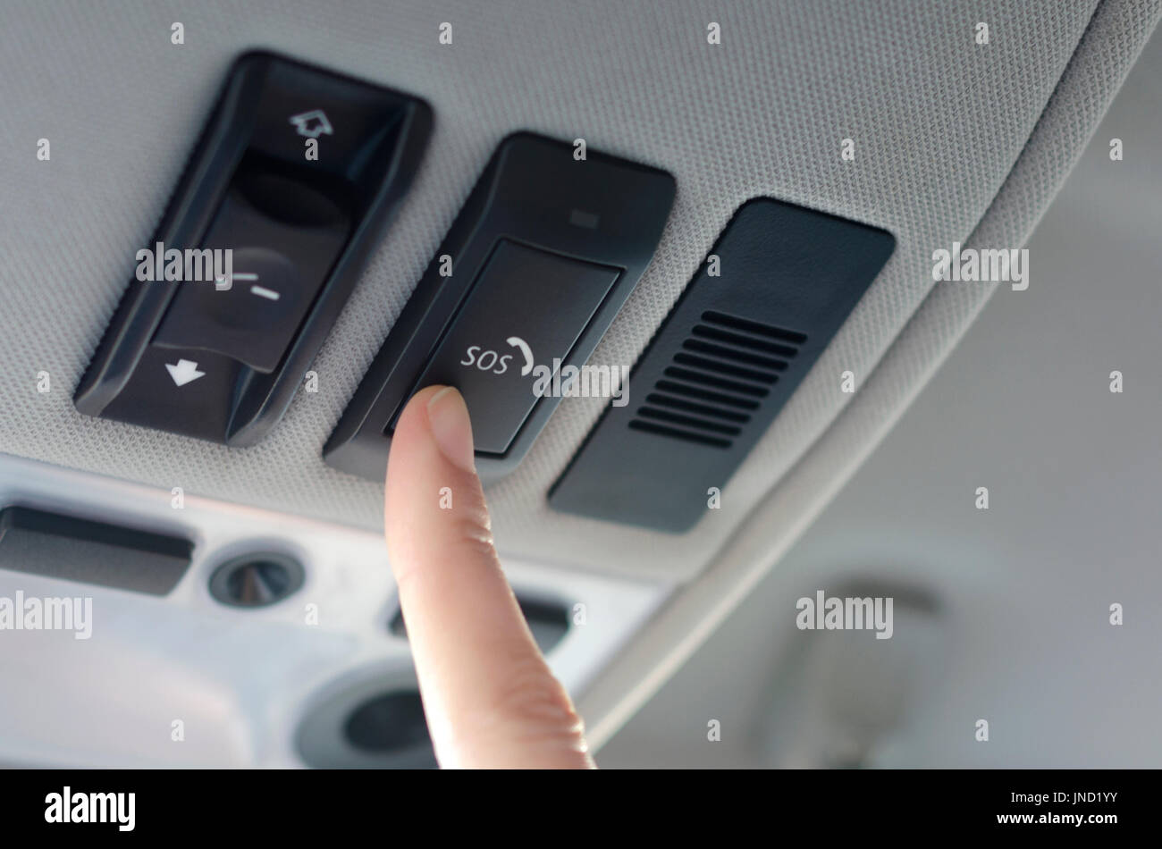 Man's finger pressing emergency sos button to contact with call center to ask for help after car accident Stock Photo