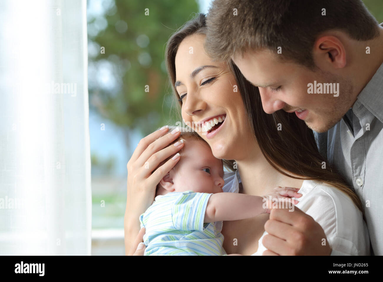 Portrait of a proud parents holding their baby at home Stock Photo