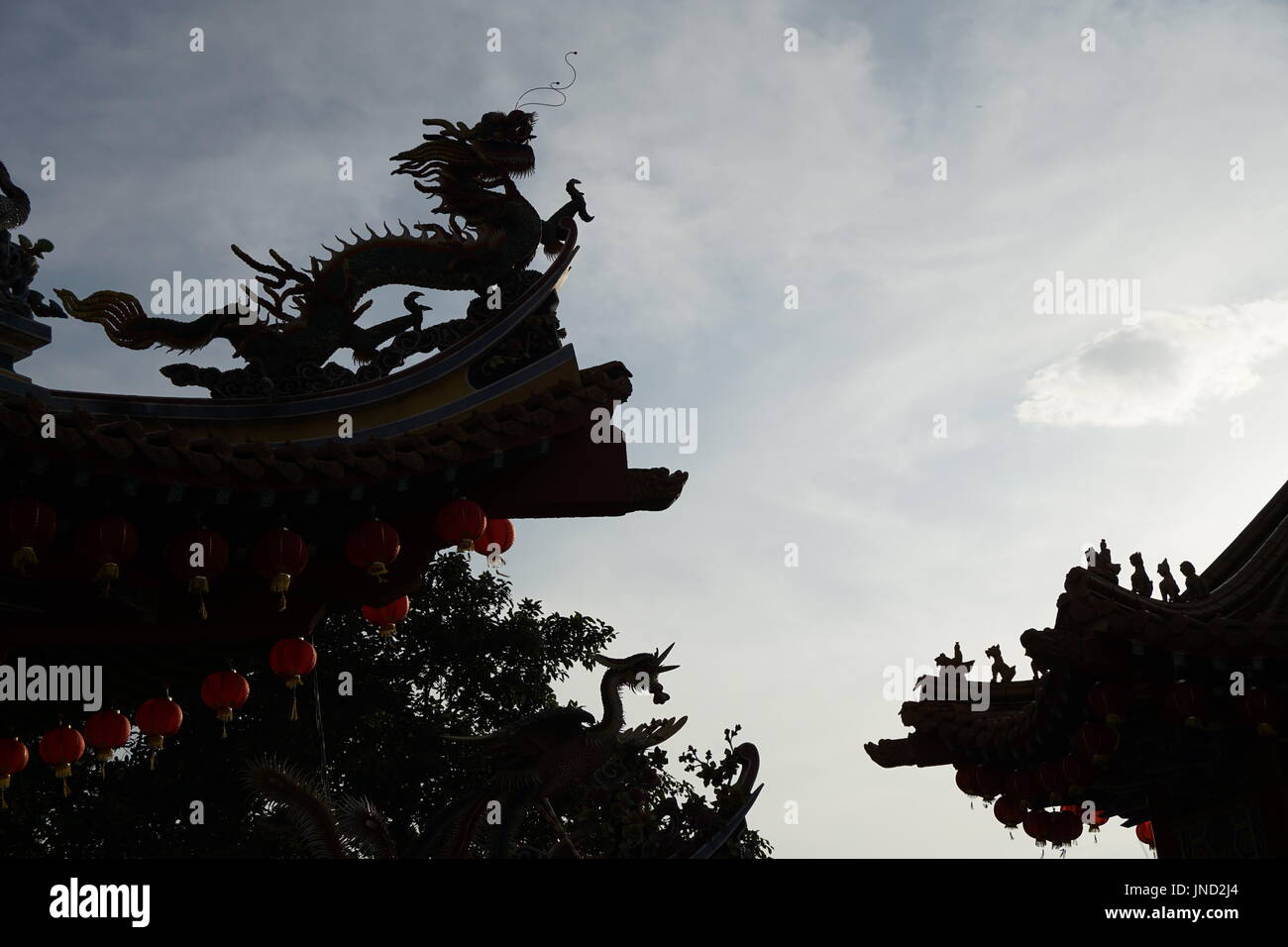 silhouette of dragon on temple roof Stock Photo