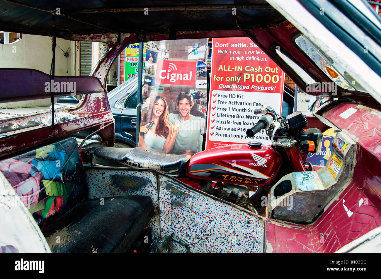 Tricycle taxi and street advertising, Rizal Avenue, Puerto Princesa, Palawan, Philippines Stock Photo