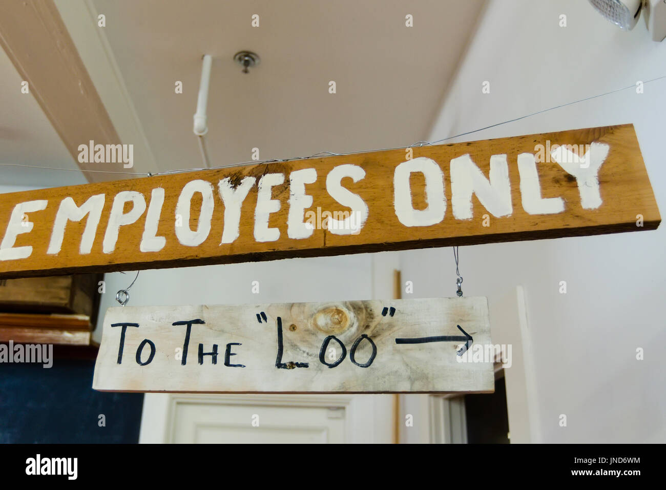 Wooden Signs Employees Only And To The Loo Hanging From
