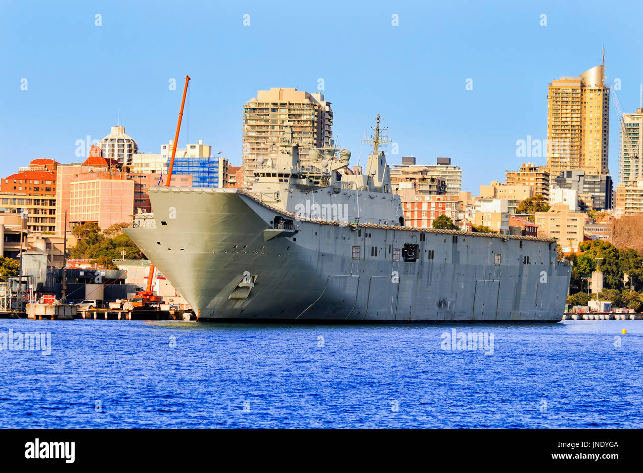 Lead flagship landing helicopter carrier of Canberra-class docked in Sydney Woolloomooloo cowper wharf on military service of Royal Australian Navy. Stock Photo