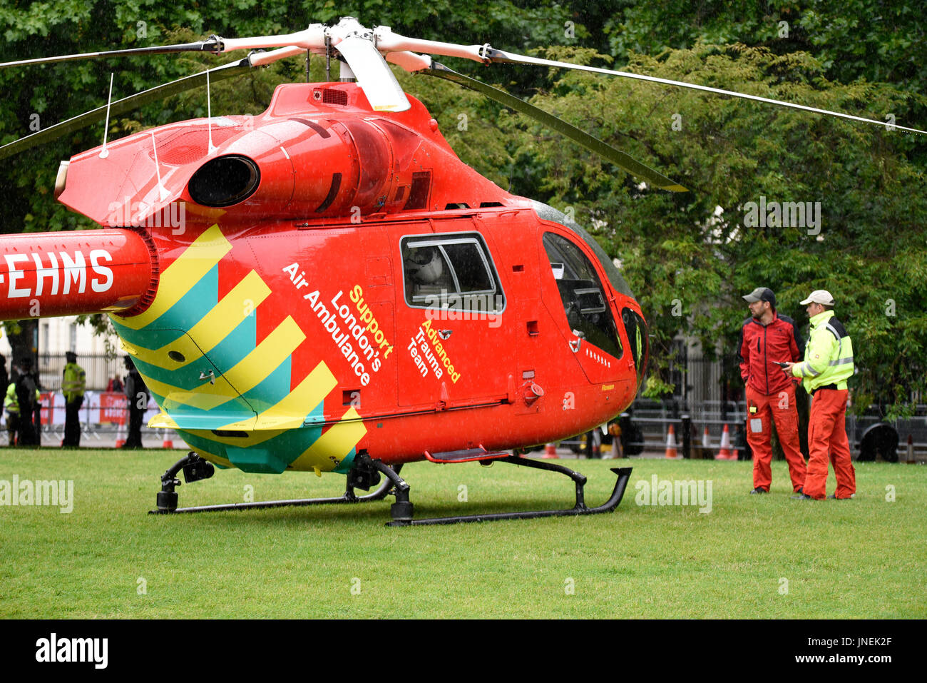 London's Air Ambulance G-EHMS landed on the green space between Birdcage Walk and Buckingham Palace in response to an incident at Victoria Station Stock Photo