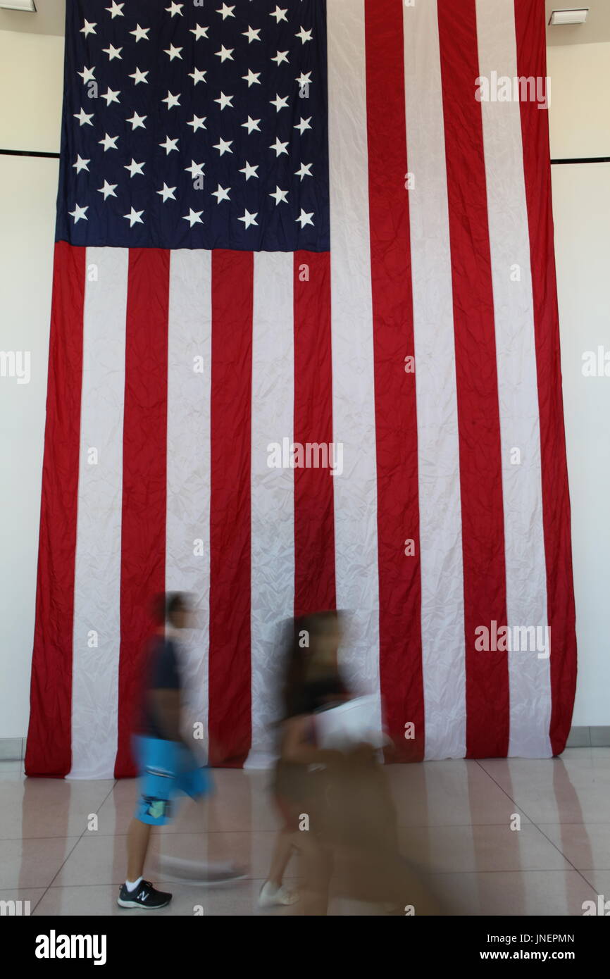 American flag hangs over the wall at the 2017 Politicon in Pasadena, CA. Photo credit: Todd Felderstein Stock Photo
