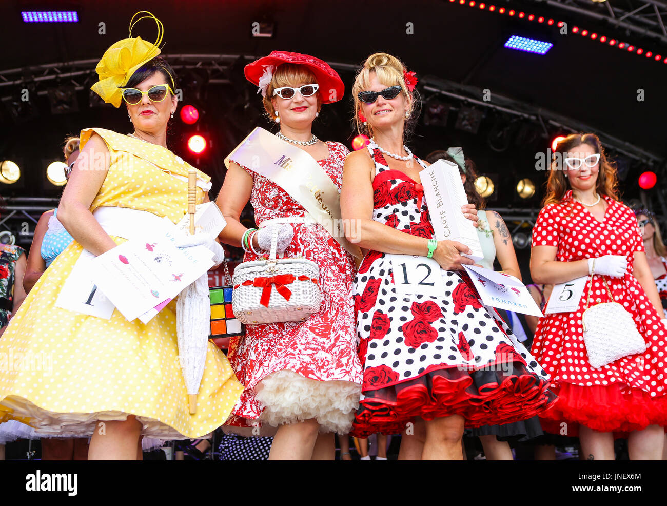 Wettenberg, Germany. 30th July, 2017. Miss Petticoat Contest at Golden Oldies Festival in Wettenberg, Germany. Miss Petticoat 2017 is Britta Ullmann (middle), from Giessen, Hesse, Germany. 3rd place: Viola Kornfeld (front left, no 1, yellow dress), from Bad Hersfeld, Hesse, Germany. 2nd place: Anke Beger (front right, no.12), from Freiberg, Saxony, Germany. The Golden Oldies Festival is an annual nostalgic festival (est. in 1989) with focus on 1950s to1970s, over 1000 exhibited classic cars and old-timers, over 50 live bands. Credit: Christian Lademann Stock Photo