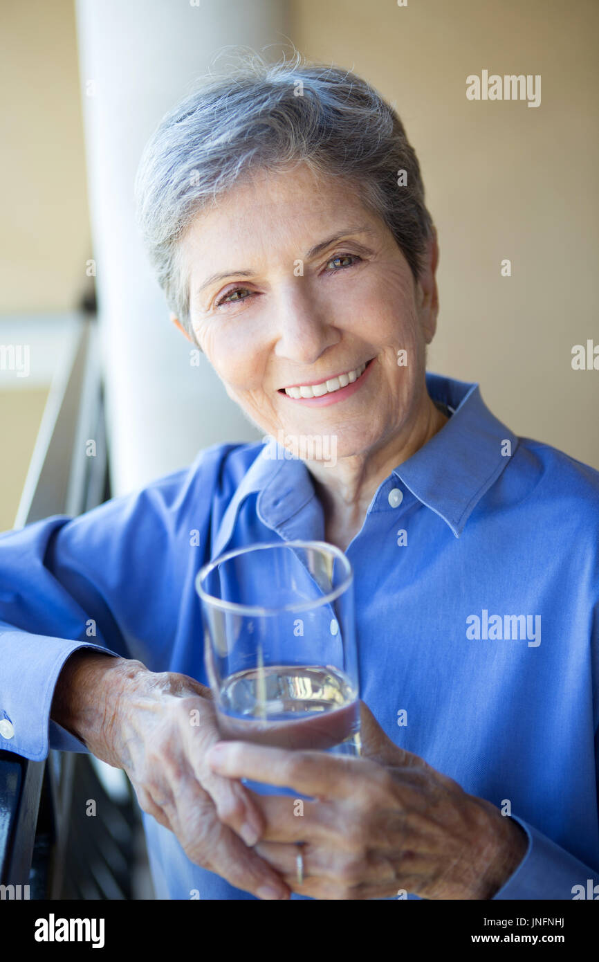 Elderly woman drinking water. Stock Photo