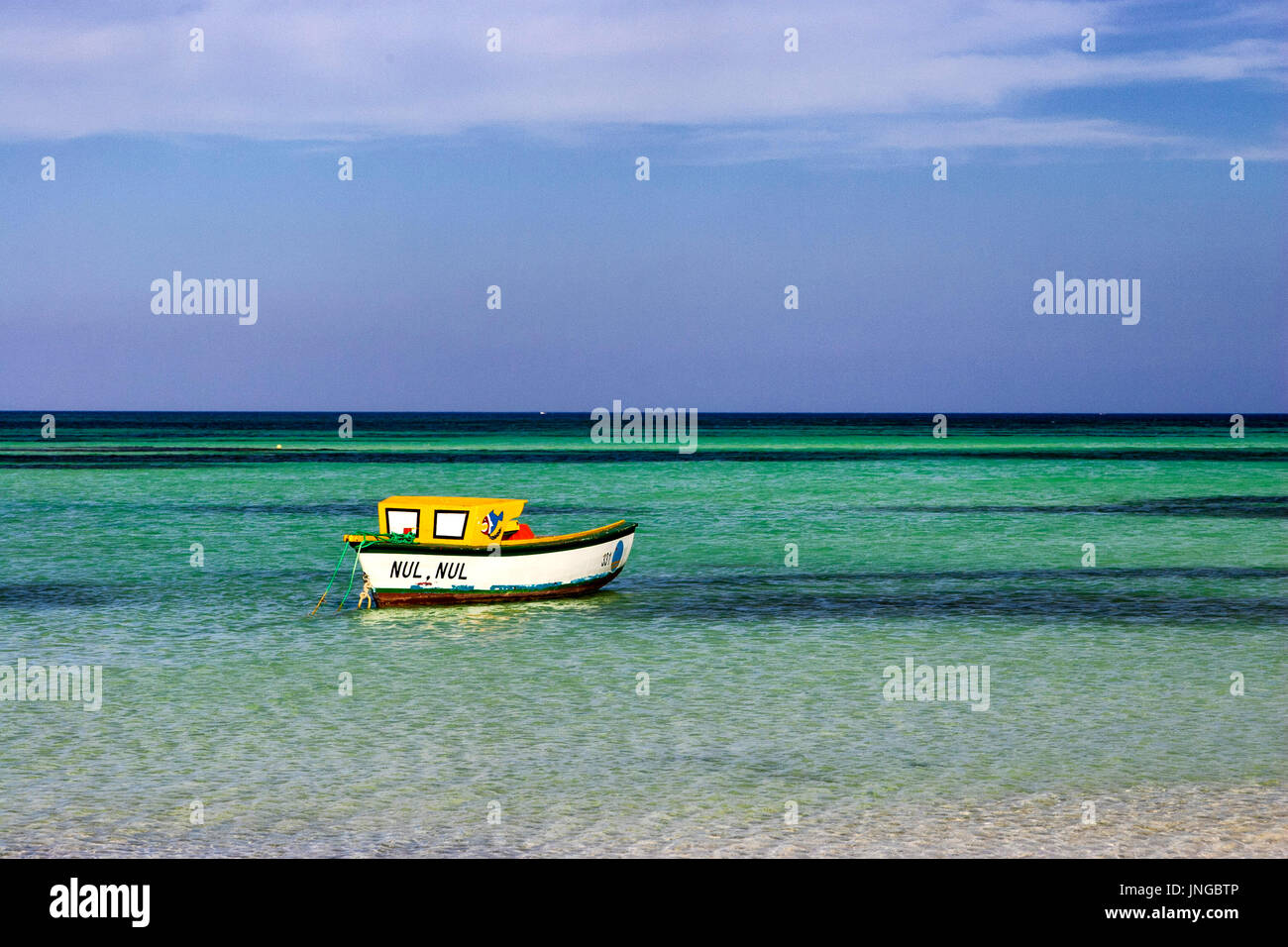 Fishing boat anchored in shallow water off Hadicurari beach, Aruba Stock Photo