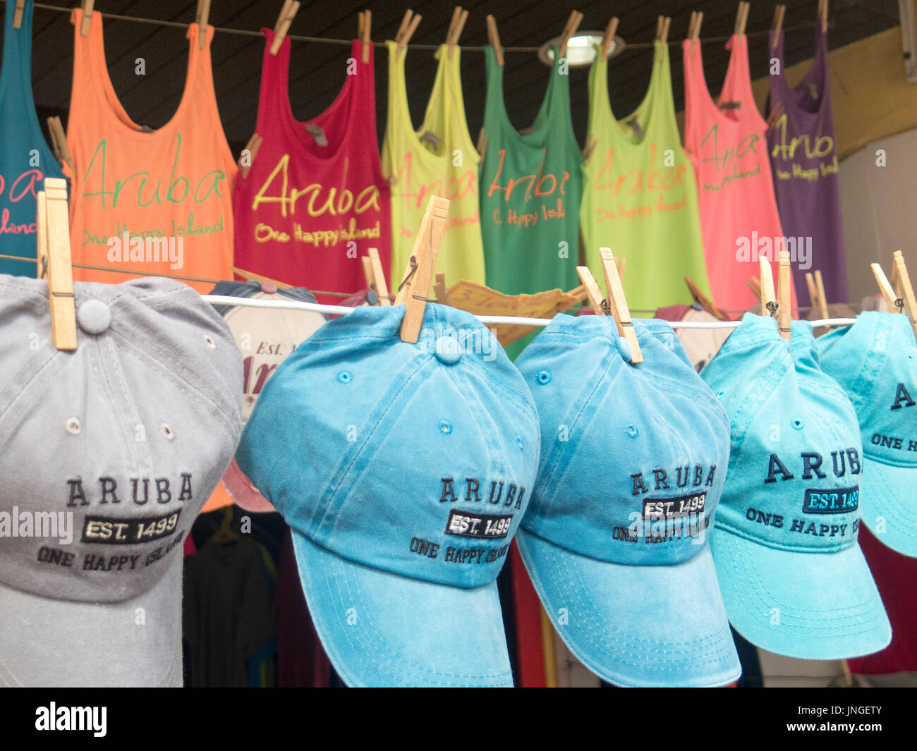 Souvenir shirts and hats for sale at a tourist market In Oranjestad