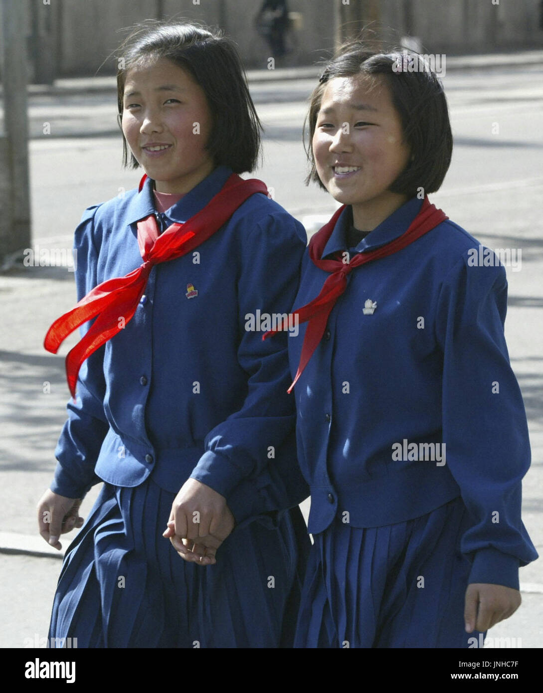 TOKYO, Japan - Young students holding hands as they stroll in downtown ...