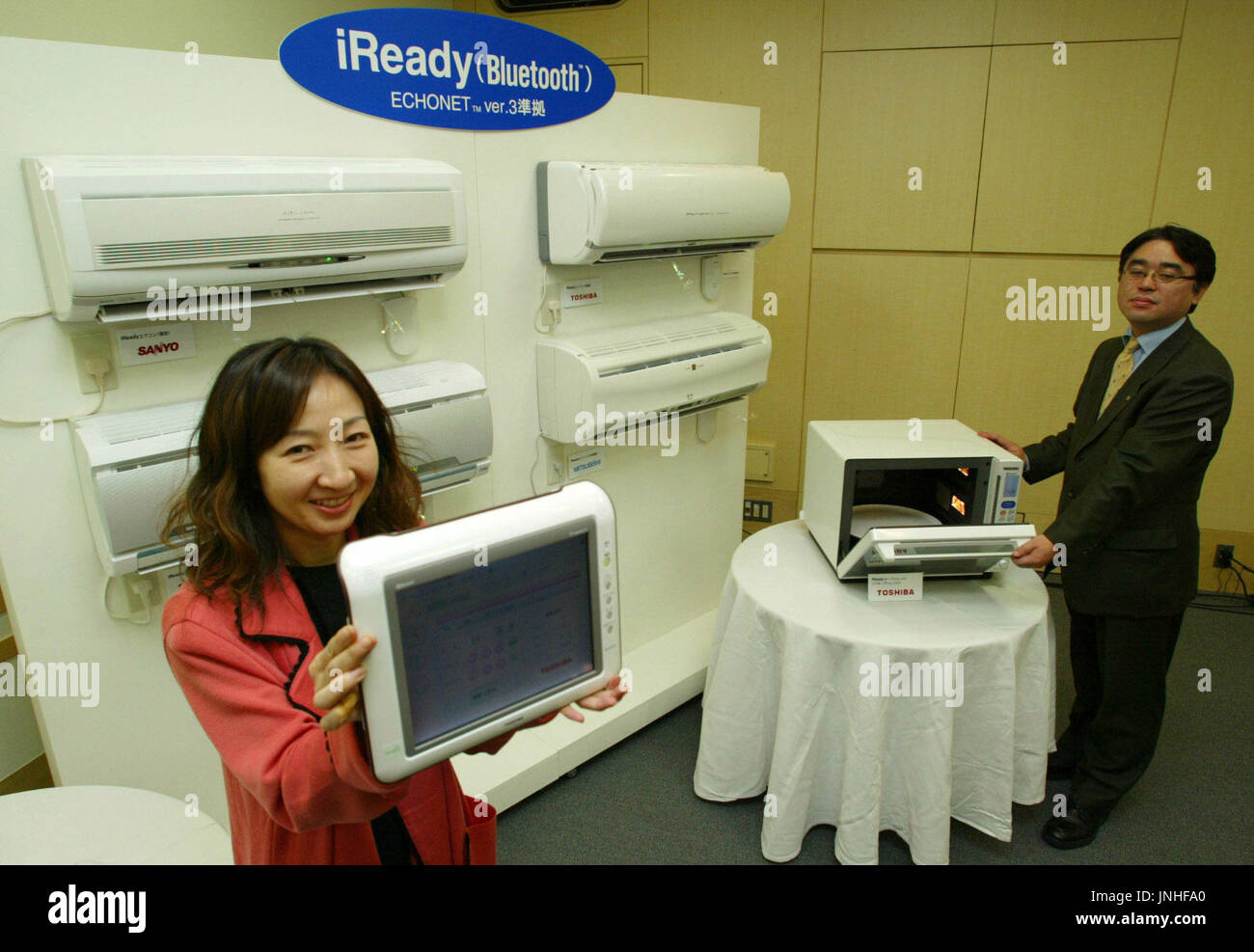 TOKYO, Japan Two clerks show off electrical appliances with builtin