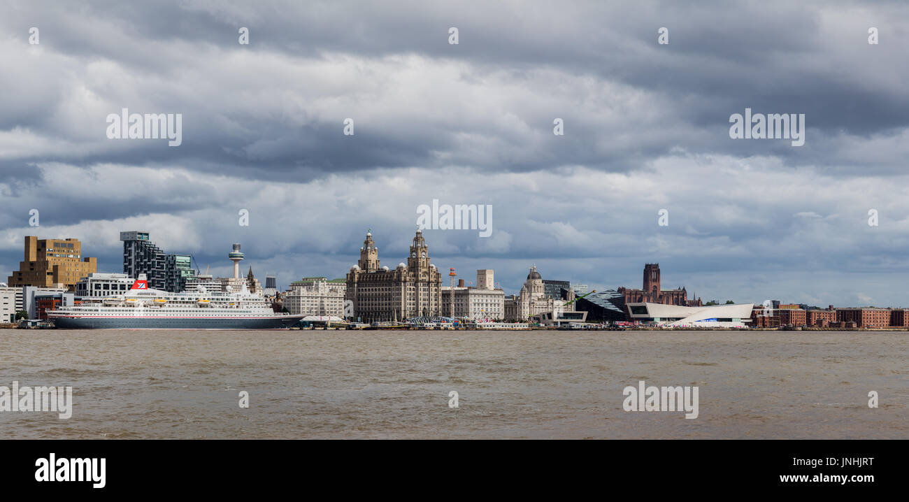 A multiple image panorama of the cruise ship MV Boudicca berthed on the Liverpool waterfront, captured under a stormy sky during the summer of 2017. Stock Photo