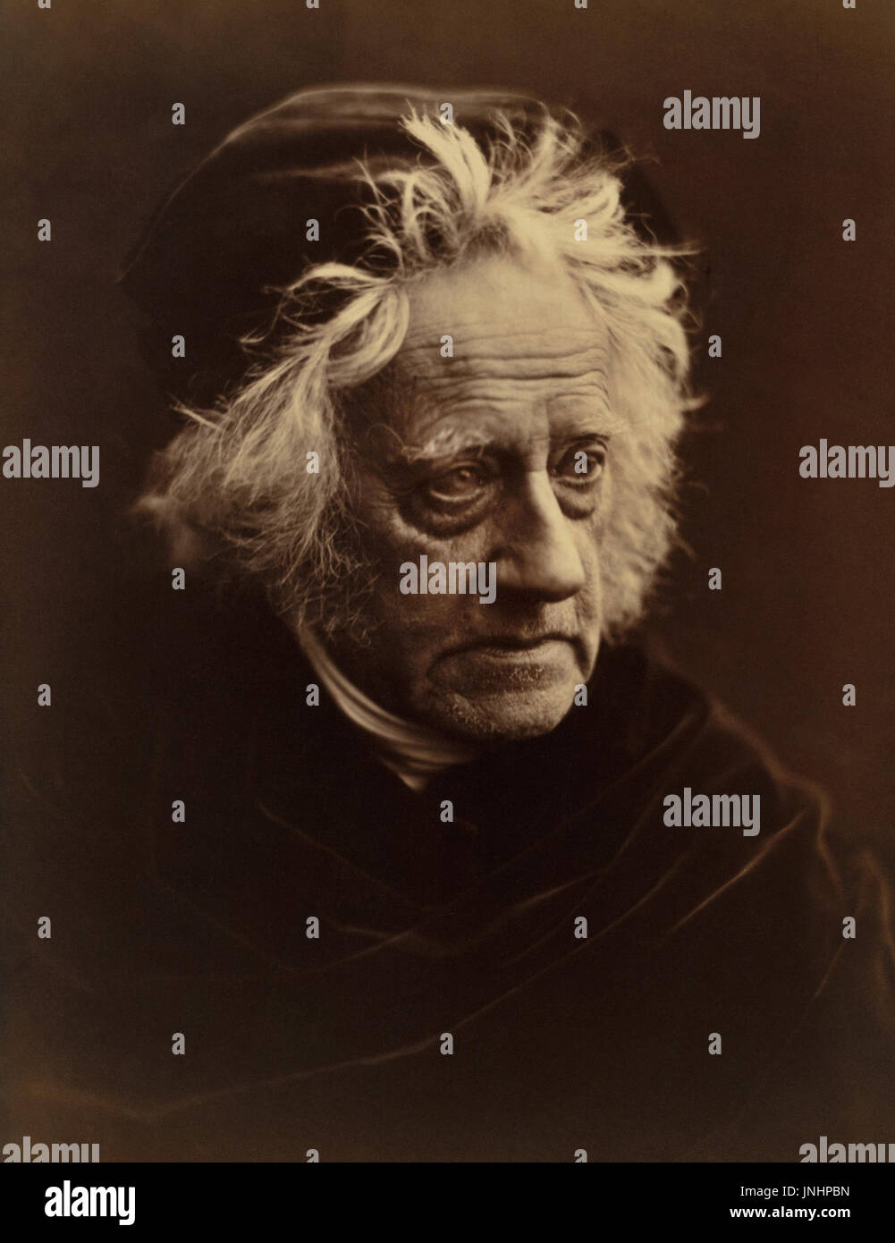 Sir John Herschel (1792-1871) was an English polymath, astronomer, mathematician, chemist, inventor, and key figure in the development of photography. He invented cyanotype photography and various processes that that aided other early photography pioneers, including Daguerre. Herschel is also credited with coining the term photography in 1839. (Photograph by Julia Margaret Cameron in April, 1867) Stock Photo
