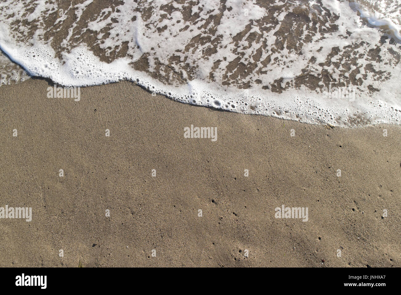 Sandy beach with small waves - tuscany impressions Stock Photo