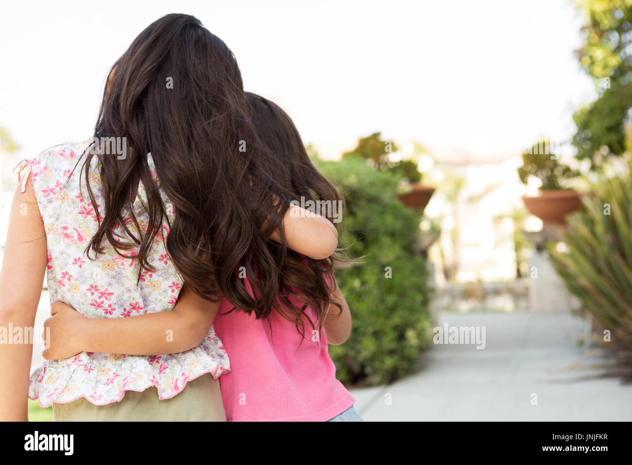 Cute little girls hugging. Sisters and best friends. Stock Photo