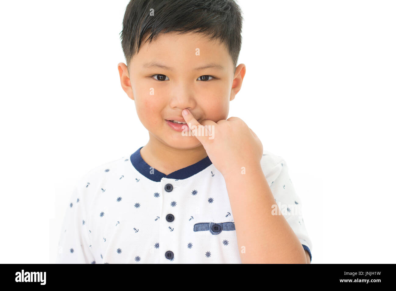 little boy picking his nose isolated on white background Stock Photo