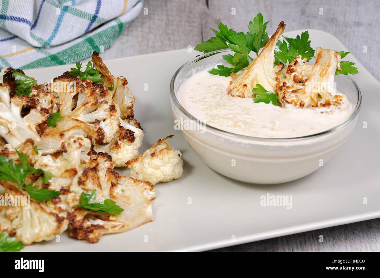 Roasted cauliflower with tahini sauce (sesame paste Stock Photo - Alamy