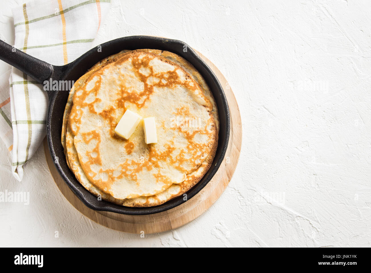 https://c8.alamy.com/comp/JNK1YK/homemade-crepes-with-butter-in-cast-iron-pan-and-ingredients-over-JNK1YK.jpg