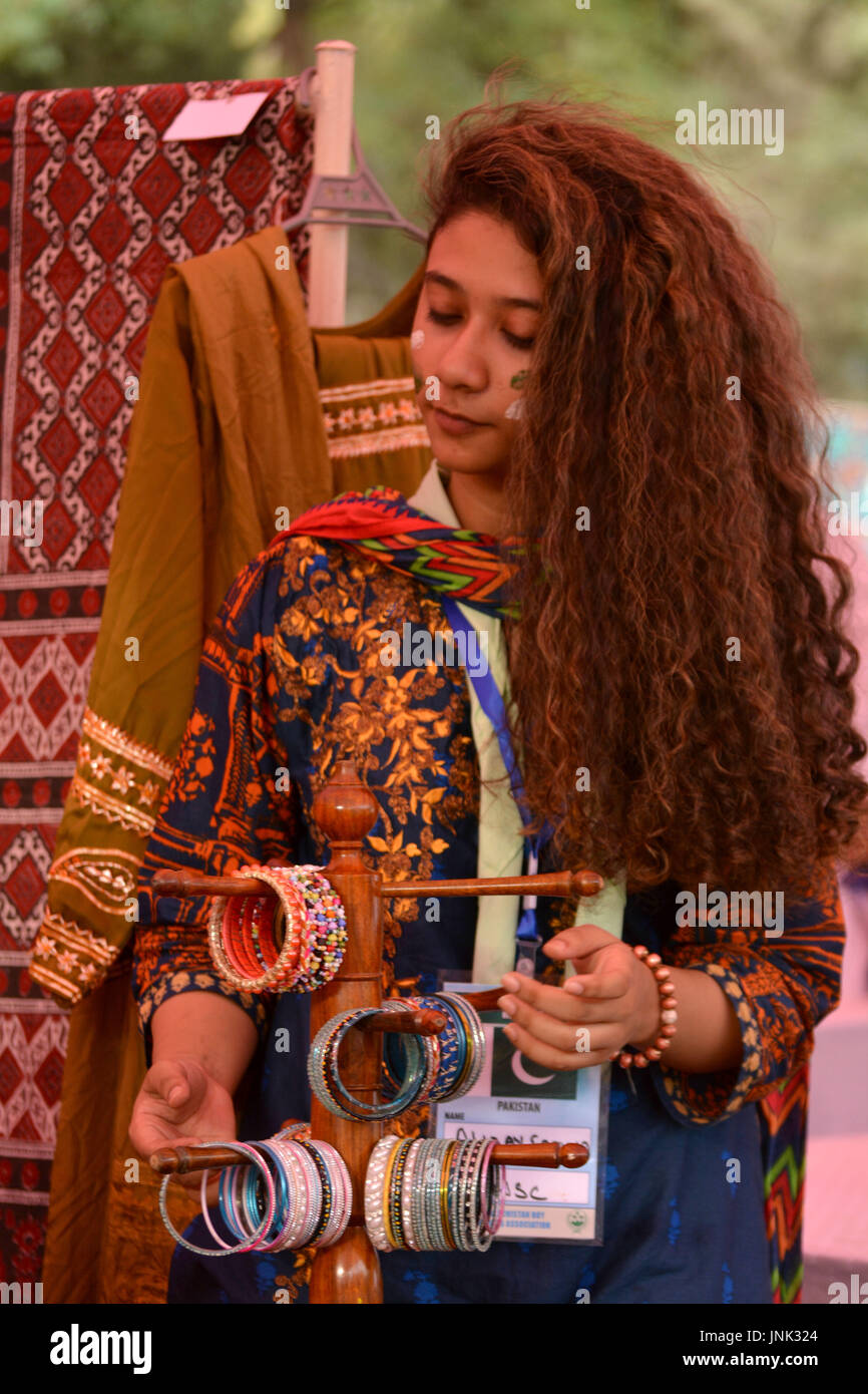 QUETTA, PAKISTAN. July-29 2017: A Girl participant setting the bangles in a cultural stall in global village activity during the committee session reg Stock Photo