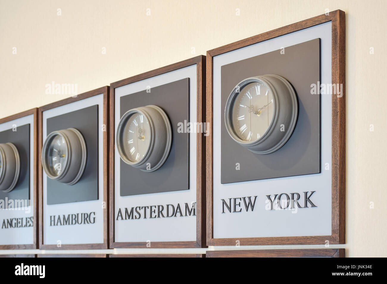 wooden clocks showing the time in different cities of the world on the