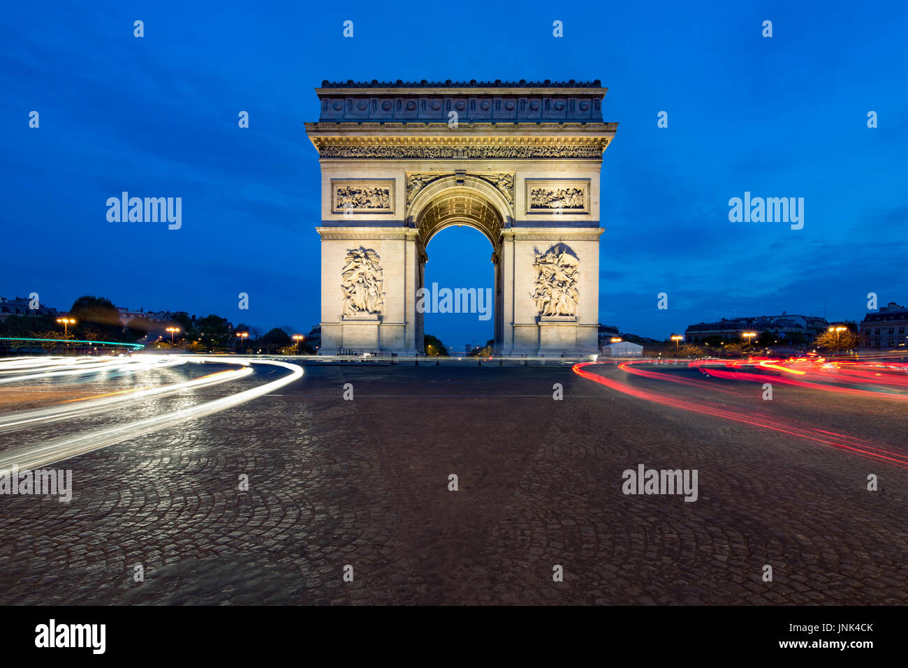 Paris street at night with the Arc de Triomphe in Paris, France. Stock Photo