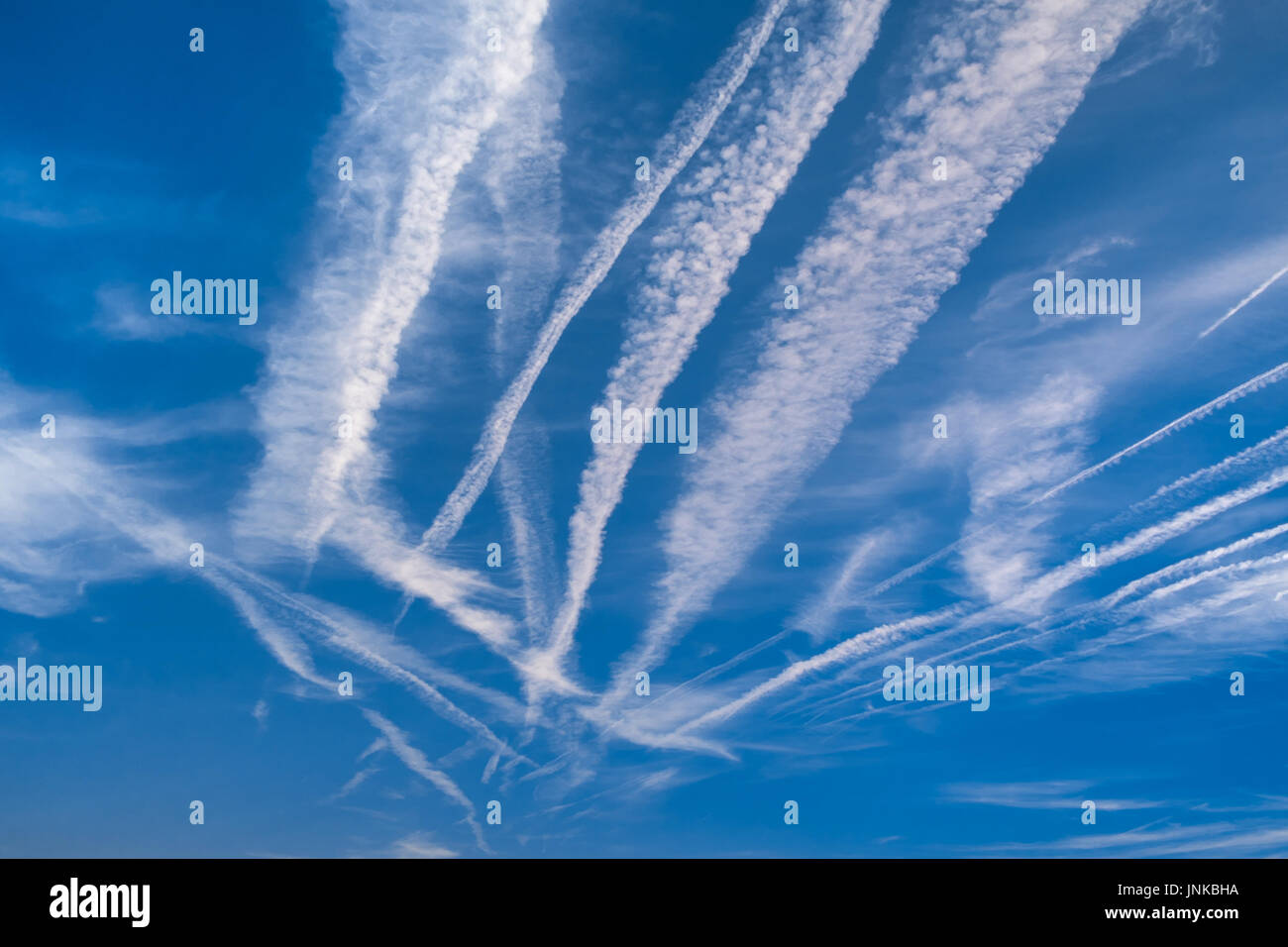 Contrails / chemtrails in blue sky - central France. Stock Photo