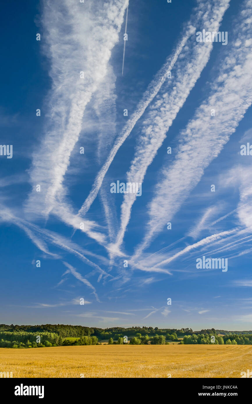 Contrails / chemtrails in blus sky - central France. Stock Photo