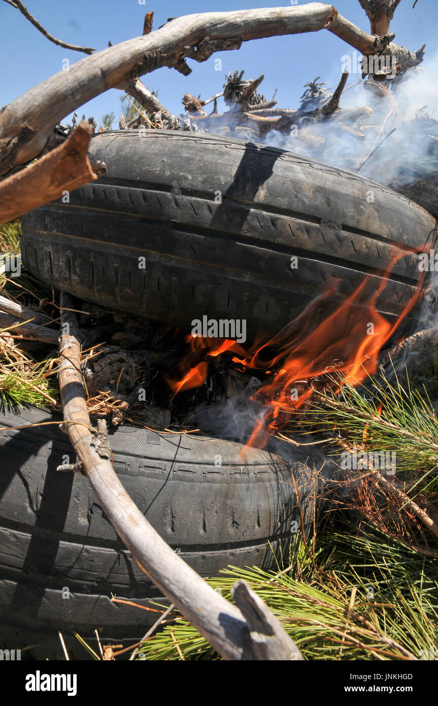 How to start a fire with old tires and branches. a set of 5 images