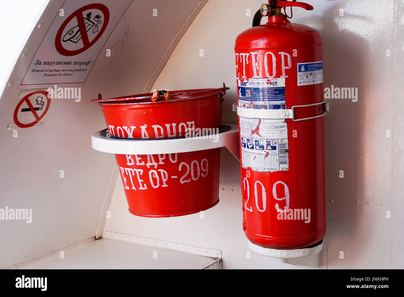 Fire extinguisher and a bucket of sand on board a ship Stock Photo - Alamy