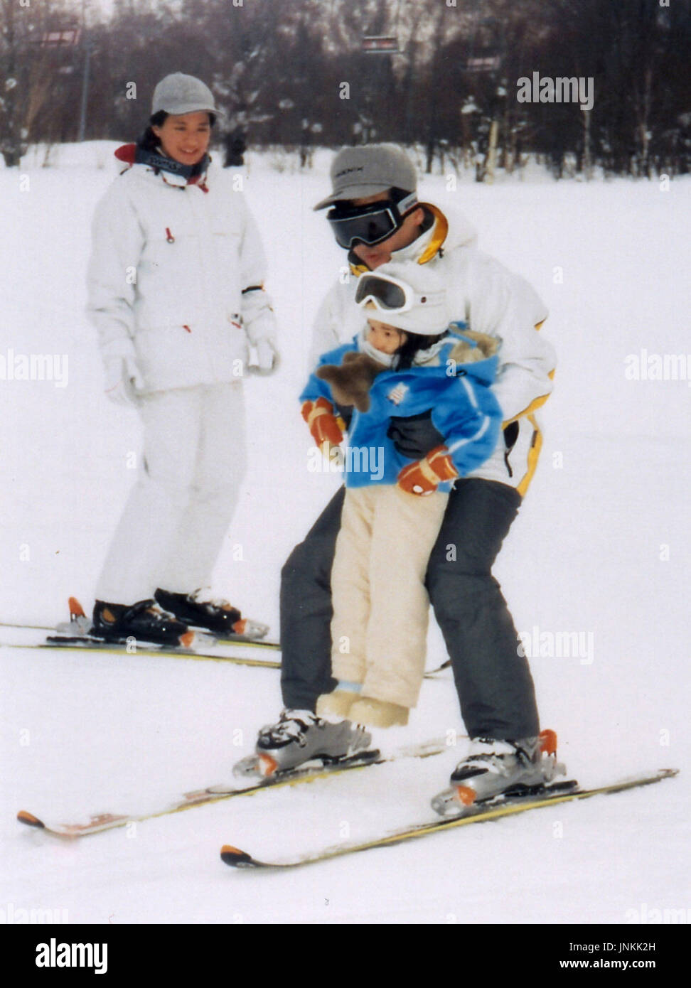TOKYO, Japan - Crown Prince Naruhito skis holding up her daughter ...