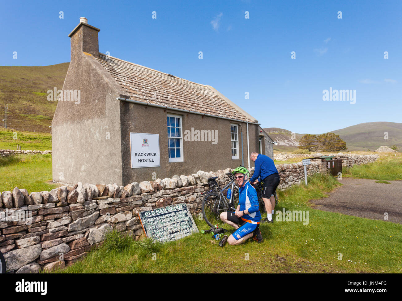 Two male cyclists with their bikes outside Rackwick Hostel, Hoy, Orkney UK Stock Photo