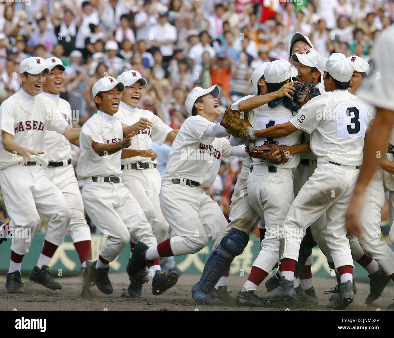 KOSHIEN, Japan Waseda Jitsugyo players celebrate after edging Komadai