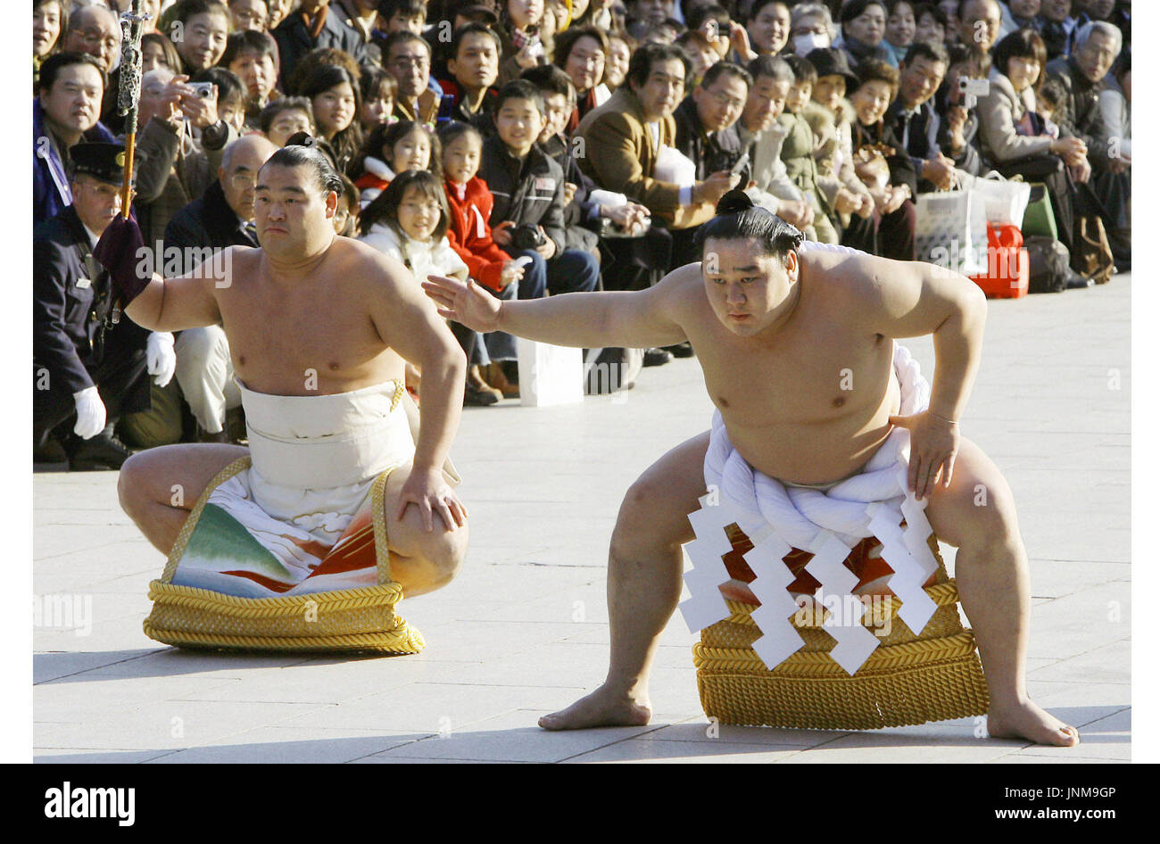 TOKYO, Japan - Mongolian Grand champion Asashoryu (R) performs the traditional dedicational sumo rites at Meiji Jingu shrine in Tokyo on Jan. 5. The event, which is held prior to the New Year Grand Sumo Tournament in Tokyo, attracted 4,500 spectators. Asashoryu is aiming for the fourth straight grand sumo title and the 20th career title -- the fifth wrestler in sumo history -- in the upcoming tournament. (Kyodo) Stock Photo