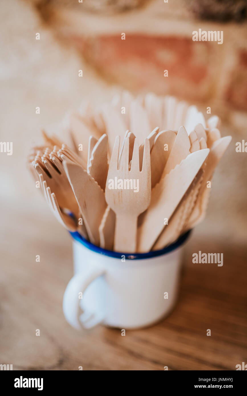 Wooden cutlery in white mug Stock Photo