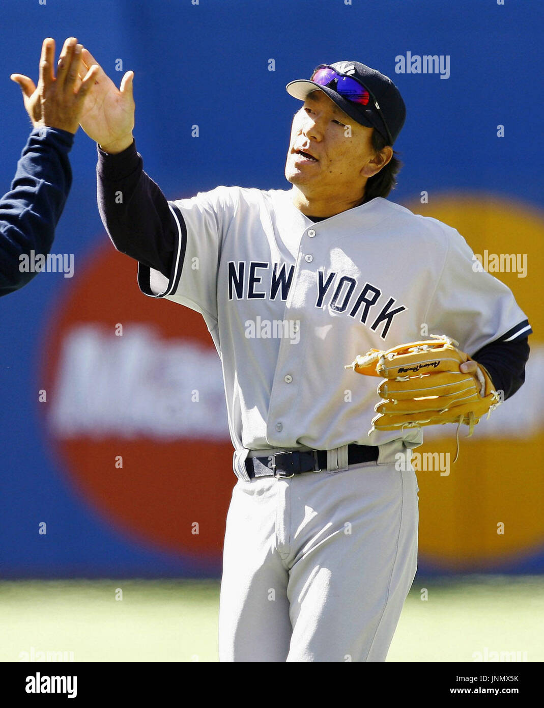 TORONTO, Canada - New York Yankees outfielder Hideki Matsui joins his teammate in celebration after the team's 3-1 win over the Toronto Blue Jays at Rogers Centre on April 19. (MLB) (Kyodo) Stock Photo