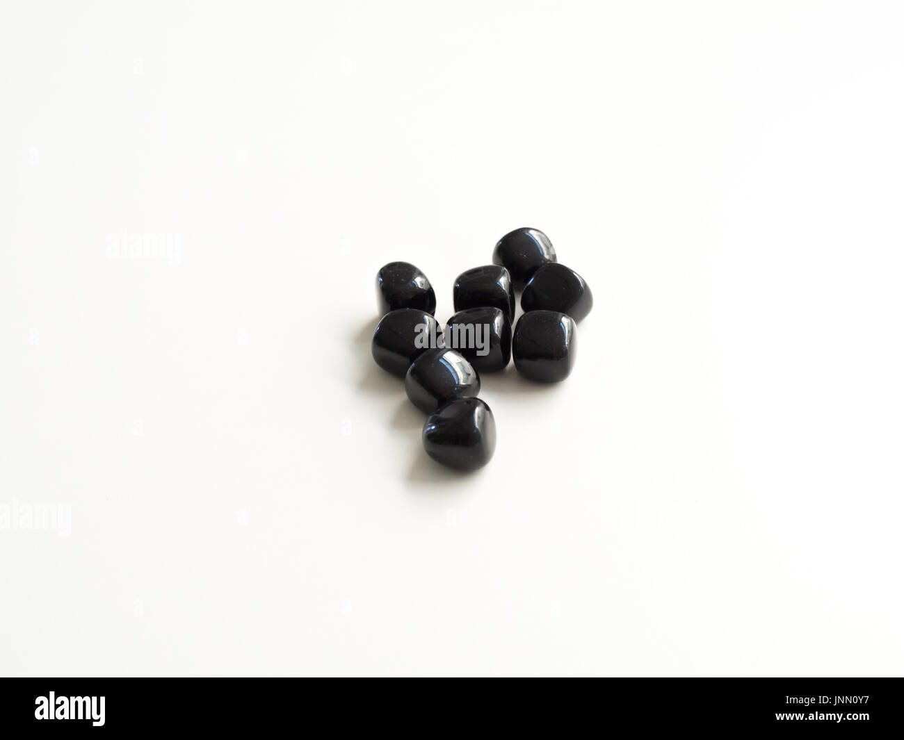 Tumbled Black Obsidian stones for crystal therapy treatments and reiki Stock Photo