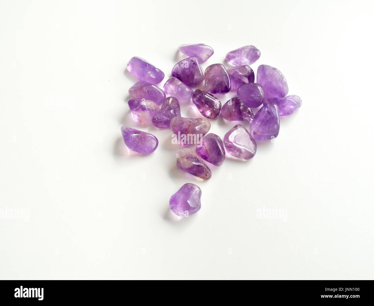 Tumbled Amethyst stones close up for crystal therapy treatments and reiki Stock Photo