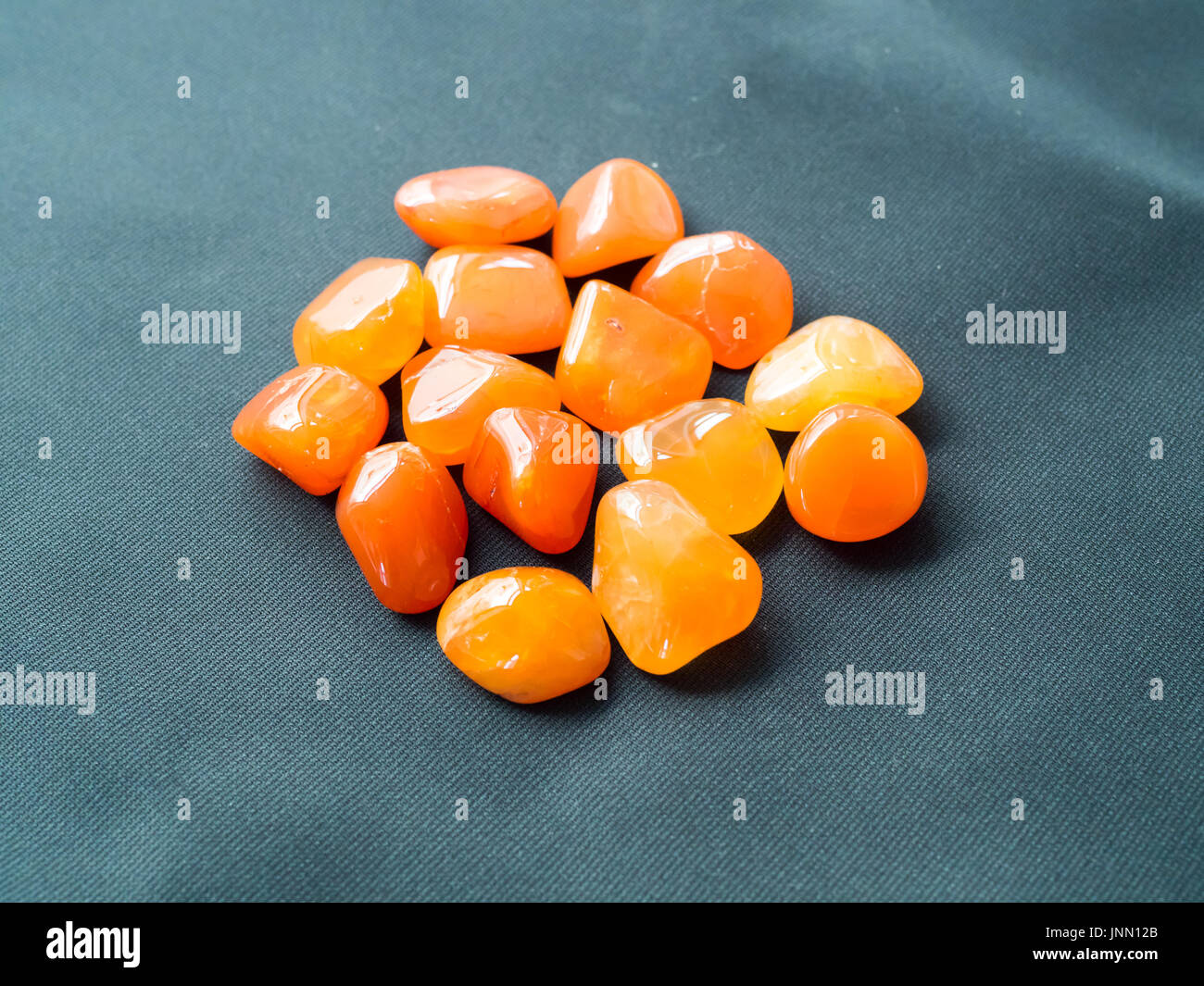 Tumbled carnelian stones close up for crystal therapy treatments and reiki Stock Photo