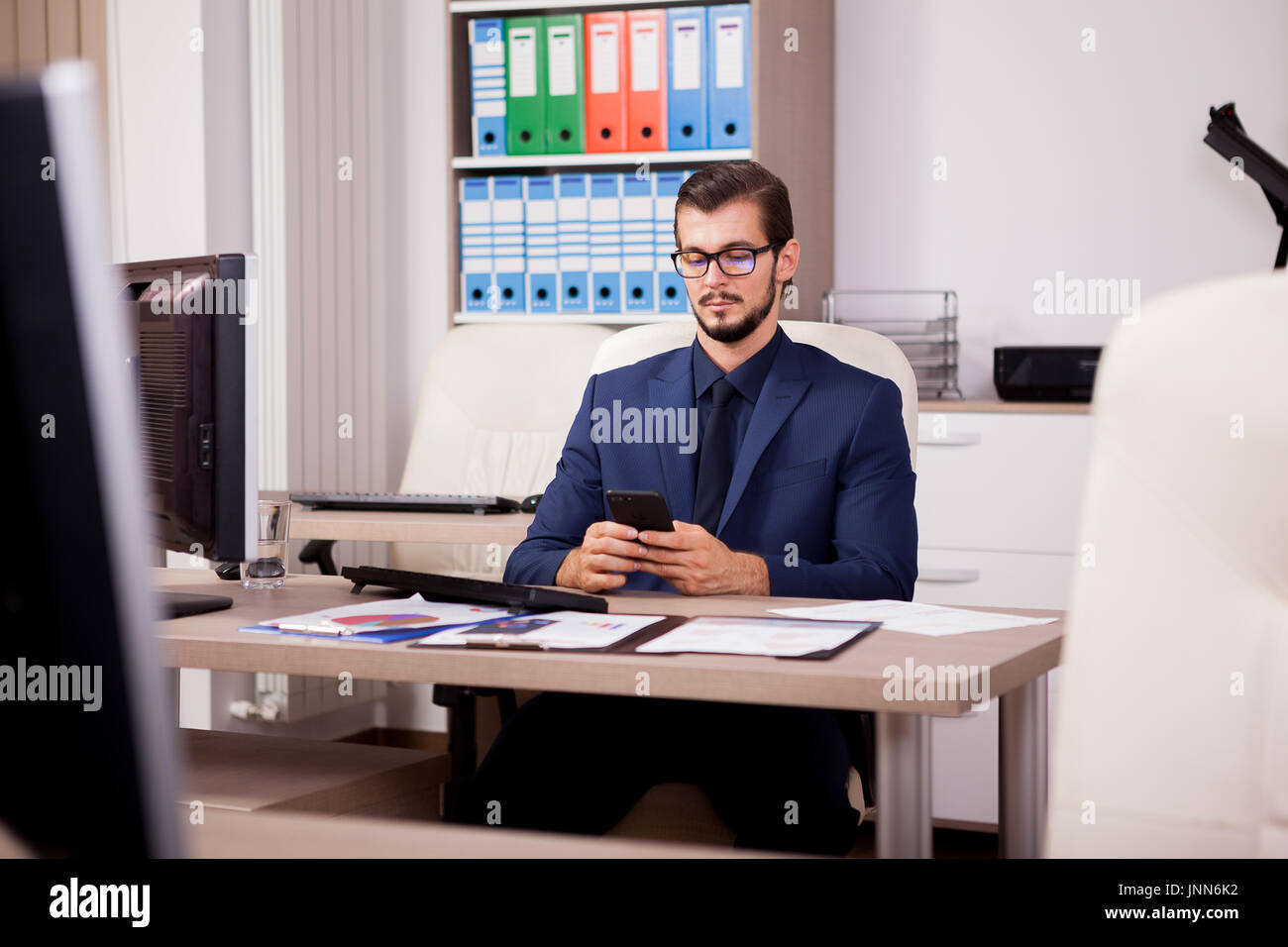 Manager with a smartphone in hands Stock Photo - Alamy