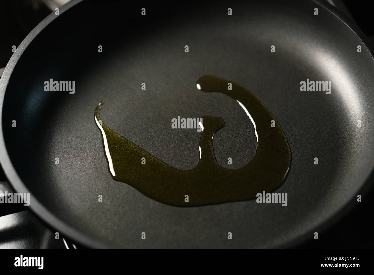 closeup olive oil in nonstick frying pan Stock Photo Alamy