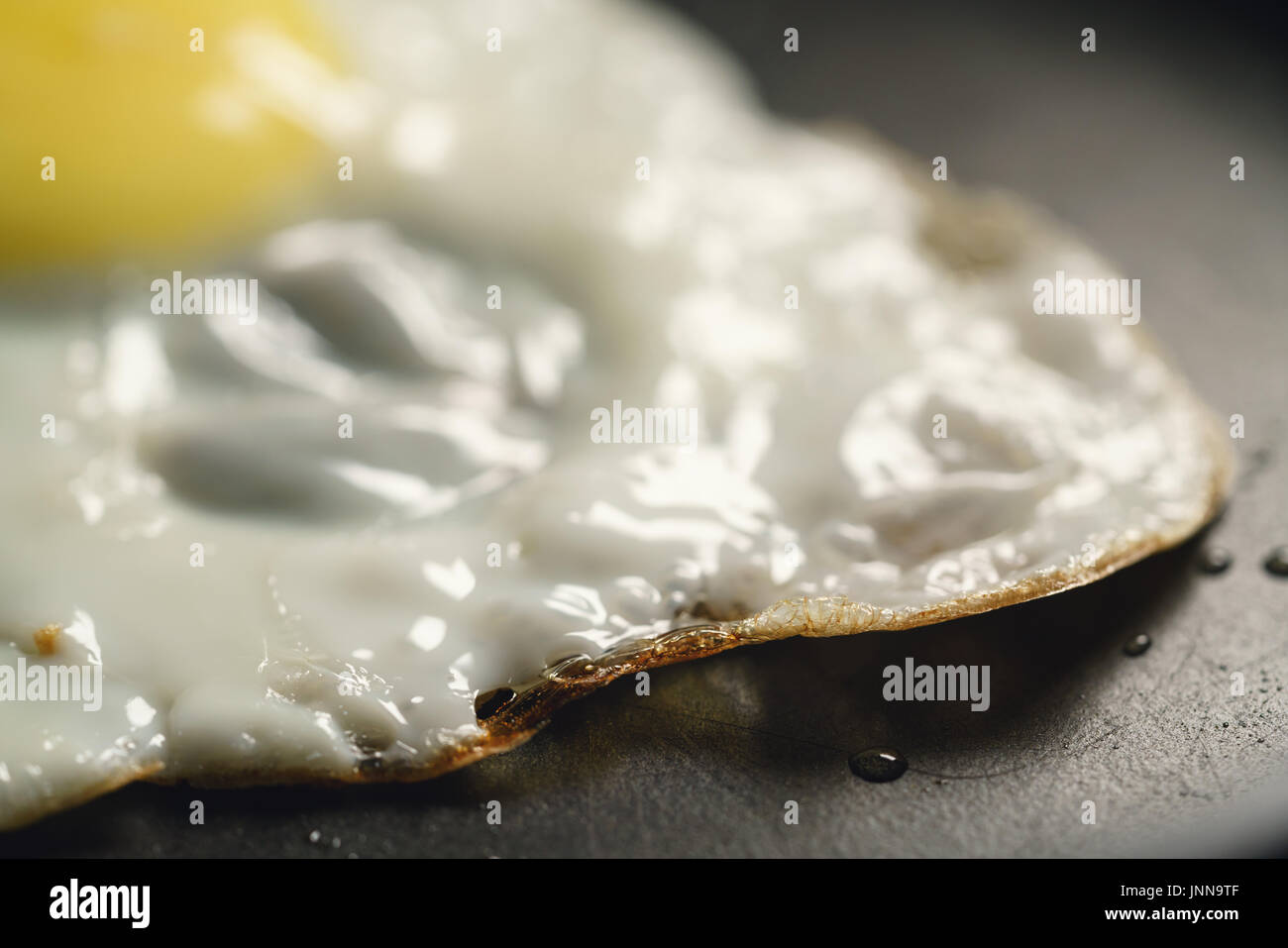 fried egg in frying pan macro shot Stock Photo