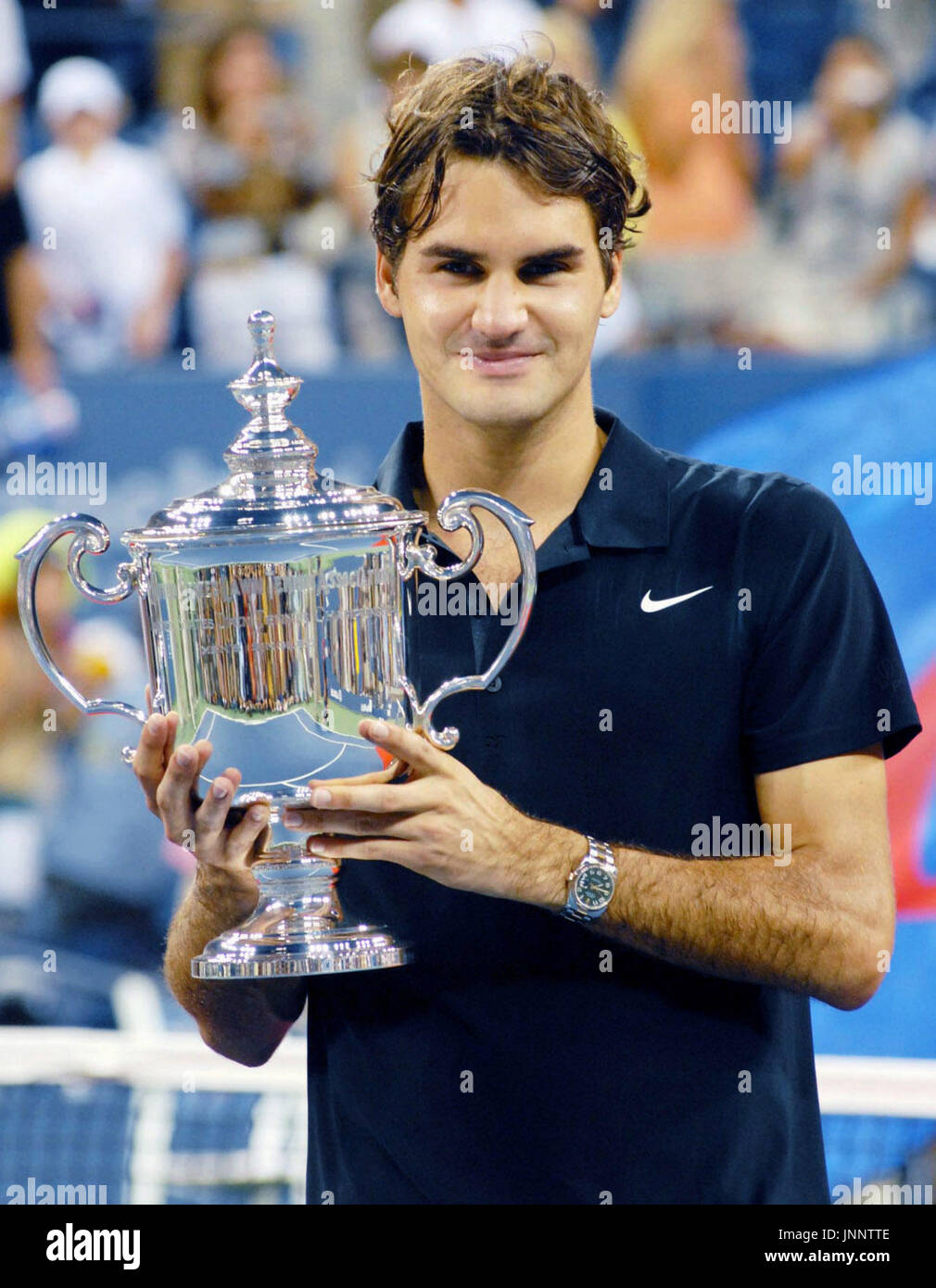 NEW YORK, United States - Roger Federer holds the winner's trophy after  beating Novak Djokovic of Serbia 7-6, 7-6, 6-4 to capture his fourth  successive U.S. Open title at Flushing Meadows, New