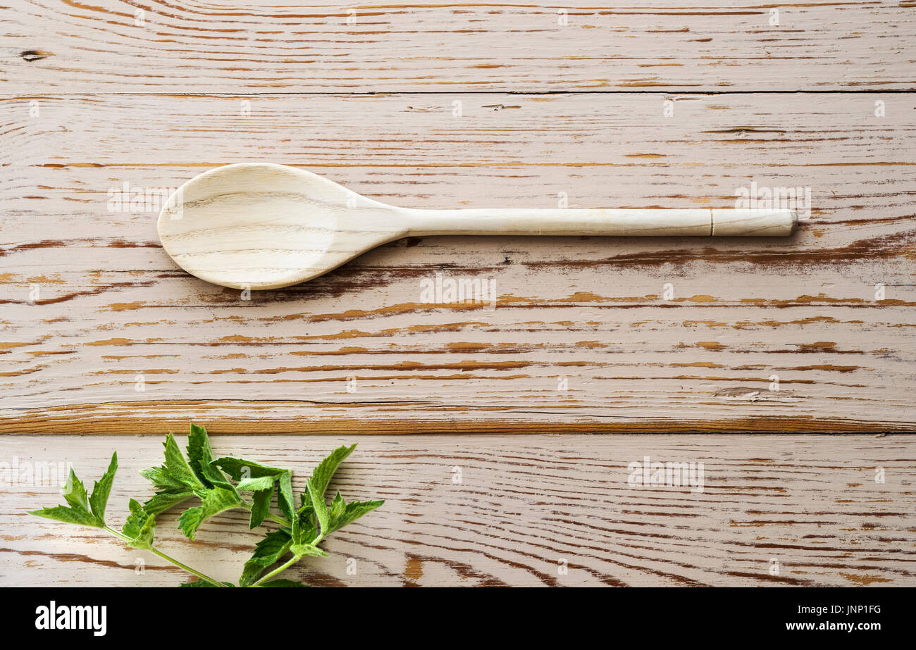 Overhead shot of wooden spoon on distressed table top. Stock Photo