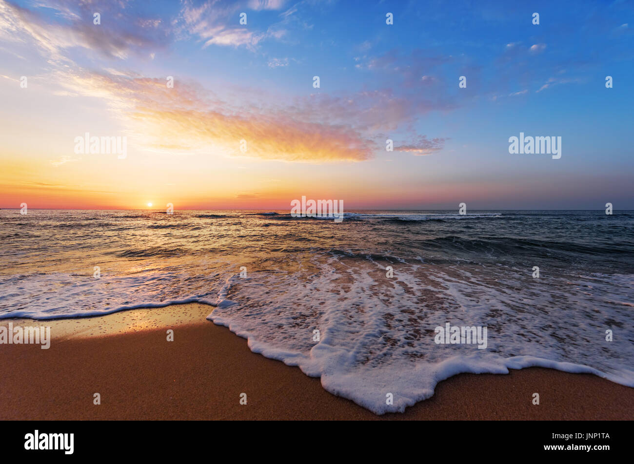 Golden sunrise sunset over the sea ocean waves Stock Photo - Alamy