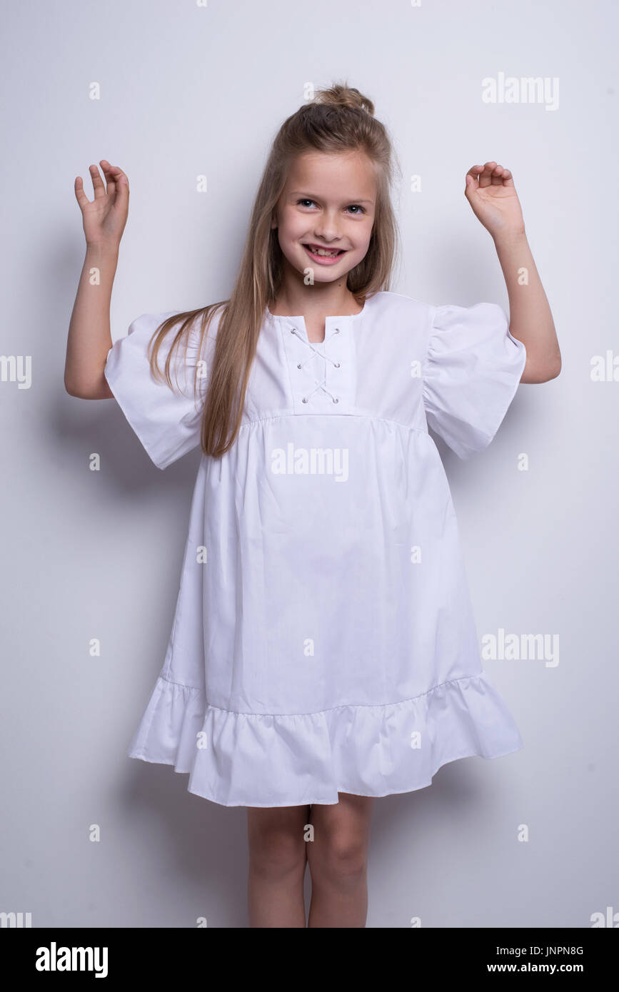 Cute little fashion model on white background. Beautiful girl studio shot Stock Photo
