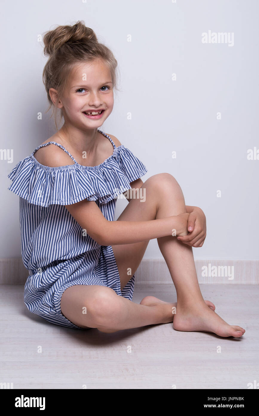 litlle model Beautiful little fashion model on white background. Portrait of cute  smiling girl posing in studio Stock Photo - Alamy