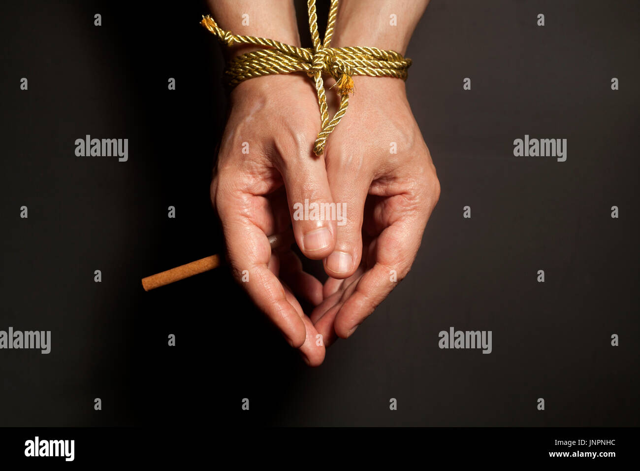 male hands are tied holding cigarettes, concept addiction, smoking,  cigarette addiction, photo taken from above Stock Photo